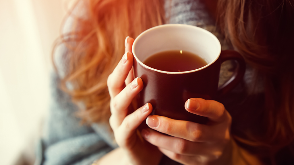Person holding mug of tea to represnt the need for adults who have a parent with an alcohol problem to look after themselves too