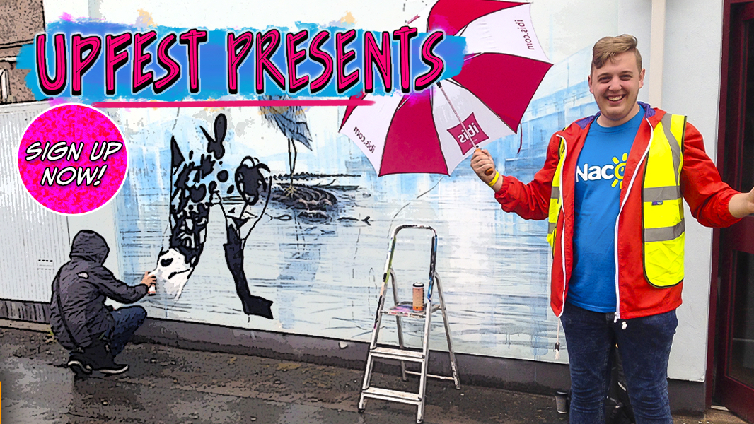 Volunteer with an umbrella standing next to artist spray painting art on a wall. Volunteers needed at Upfest Presents to raise money for Nacoa helping children affected by a parent's drinking