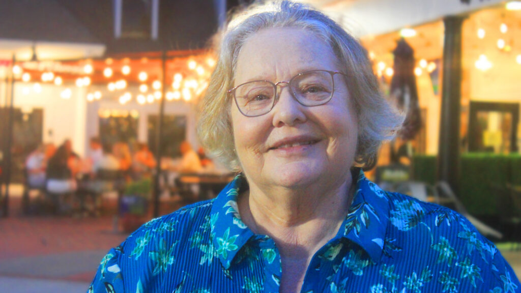 Head and shoulders of Toni Bellon, author of L.E.A.P. Linn's Emerging Adult Plan, wearing blue floral blouse. Toni shares her experience of learning to lie as the child of an alcoholic 