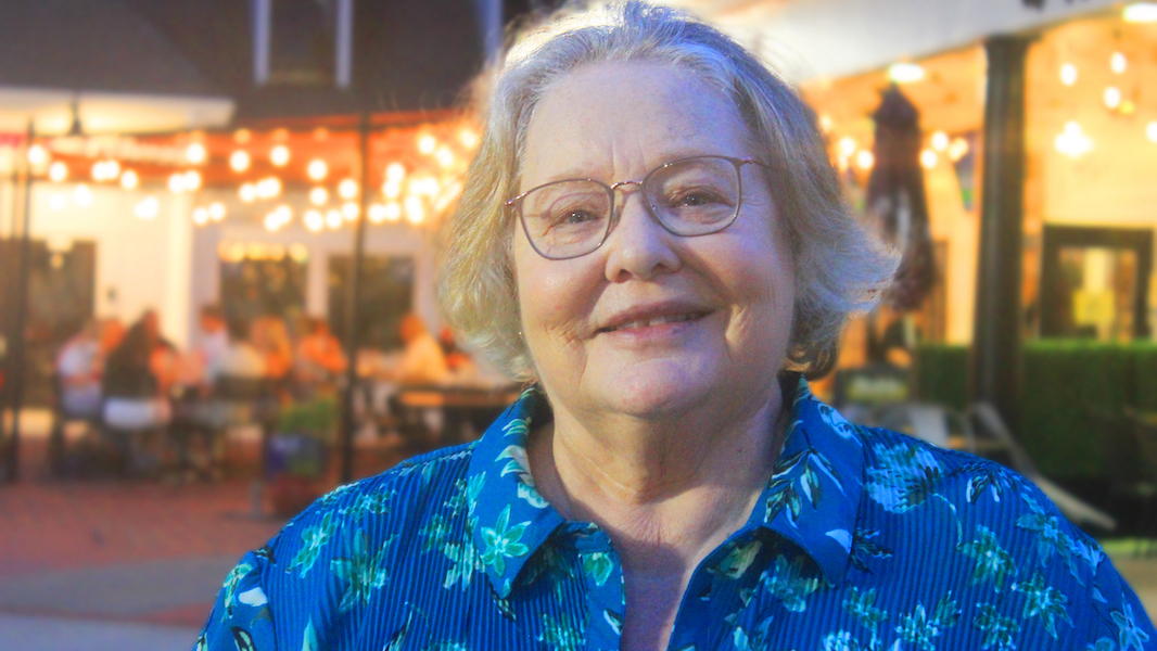 Head and shoulders of Toni Bellon, author of L.E.A.P. Linn's Emerging Adult Plan about learning to lie as the child of an alcoholic mother, wearing blue floral blouse