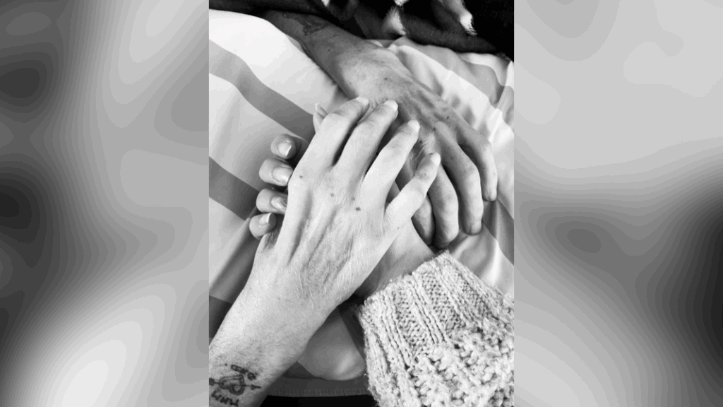 Sharing our stories is how we break the silence. Image shows three hands overlapping.